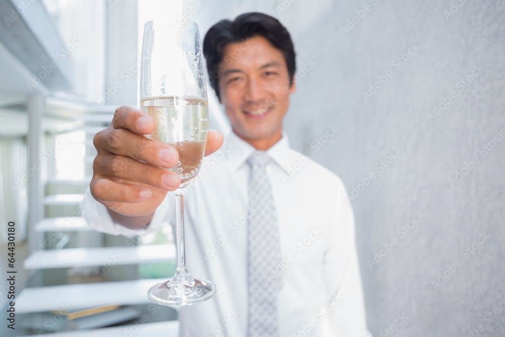 Happy man holding flute of champagne Happy man holding flute of champagne