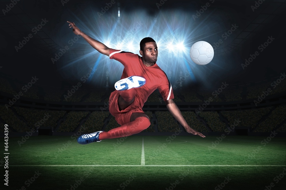 Football player in red kicking