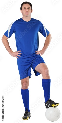 Football player in blue looking at camera