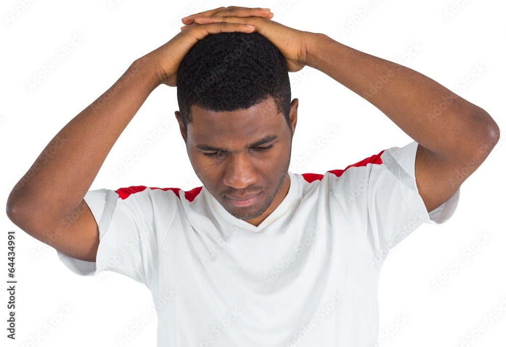 Disappointed football fan looking down Disappointed football fan looking down