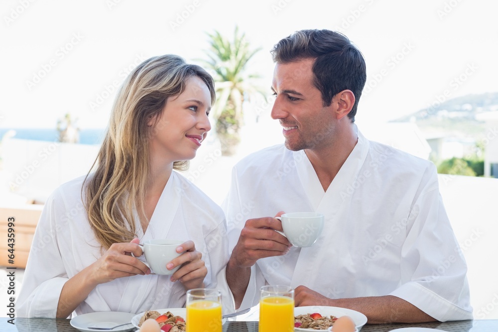 Couple looking at each other while having breakfast Couple looking at each other while having breakfast