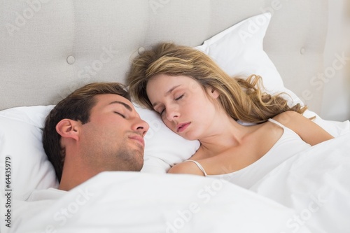 Wallpaper Mural Relaxed couple sleeping together in bed Torontodigital.ca