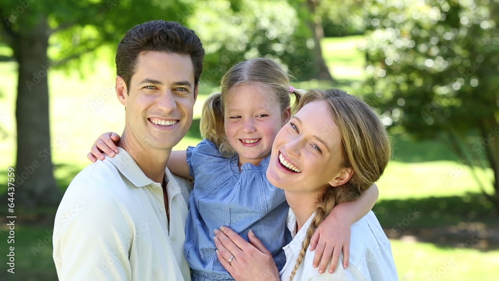 Happy parents with their little girl in the park Happy parents with their little girl in the park