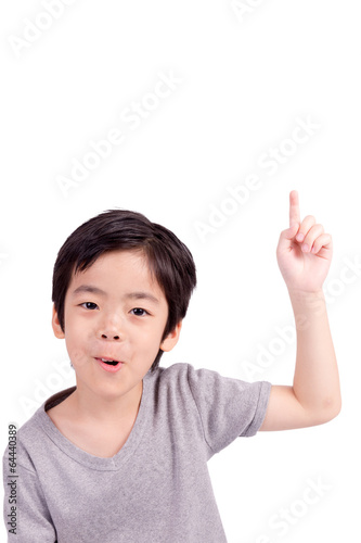 Happy boy pointing up isolated on white background