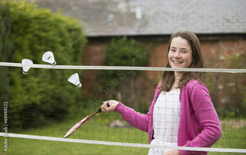 Young girl playing badminton photo
