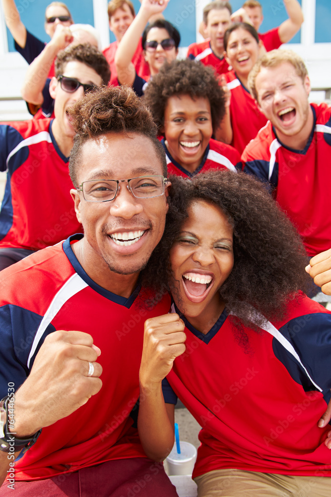 Fototapeta premium Spectators In Team Colors Watching Sports Event