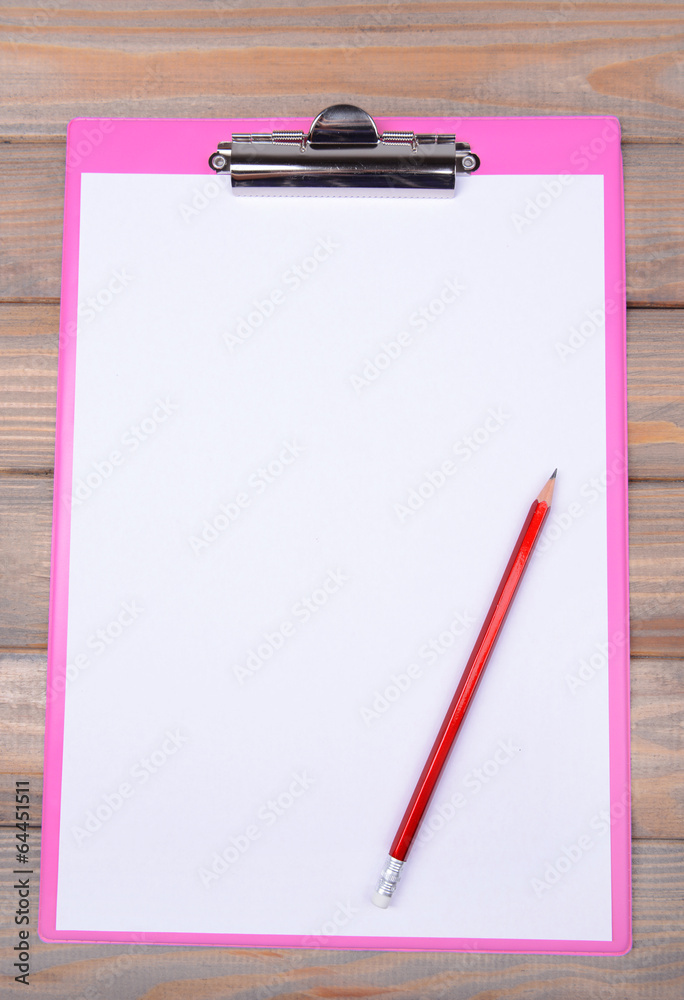 Clipboard on wooden background Clipboard on wooden background