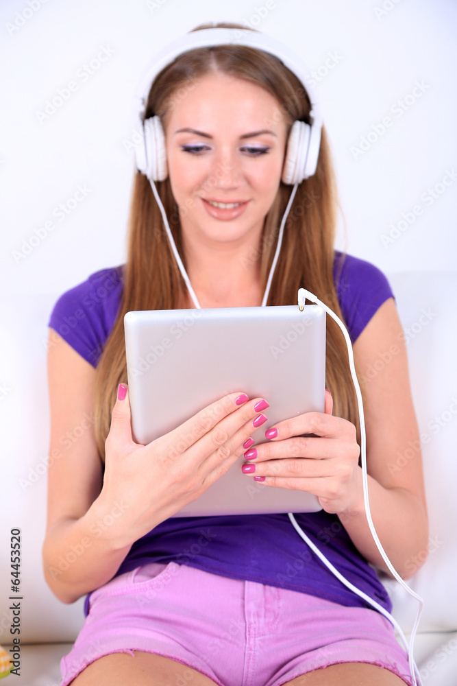 Beautiful girl with PC tablet and headphones. Beautiful girl with PC tablet and headphones.