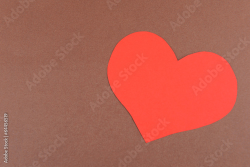 Paper heart on brown background