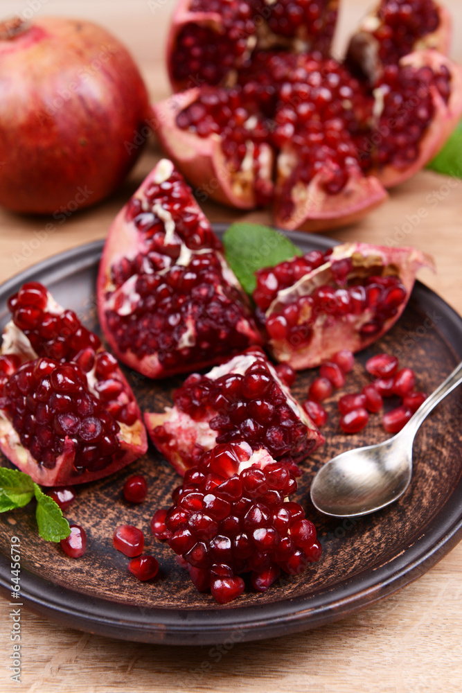 Ripe pomegranates on table close-up Ripe pomegranates on table close-up
