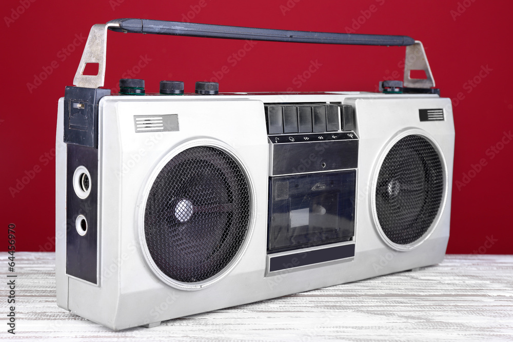 Retro cassette stereo recorder on table on red background Retro cassette stereo recorder on table on red background