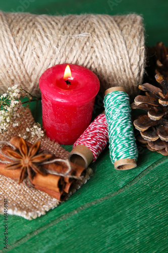 Composition with natural bump, candle, thread, cinnamon sticks