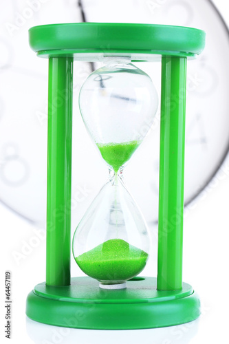 Hourglass on big clock background