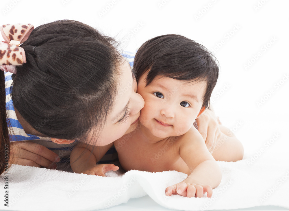 Happy mother kissing smiling child baby Happy mother kissing smiling child baby