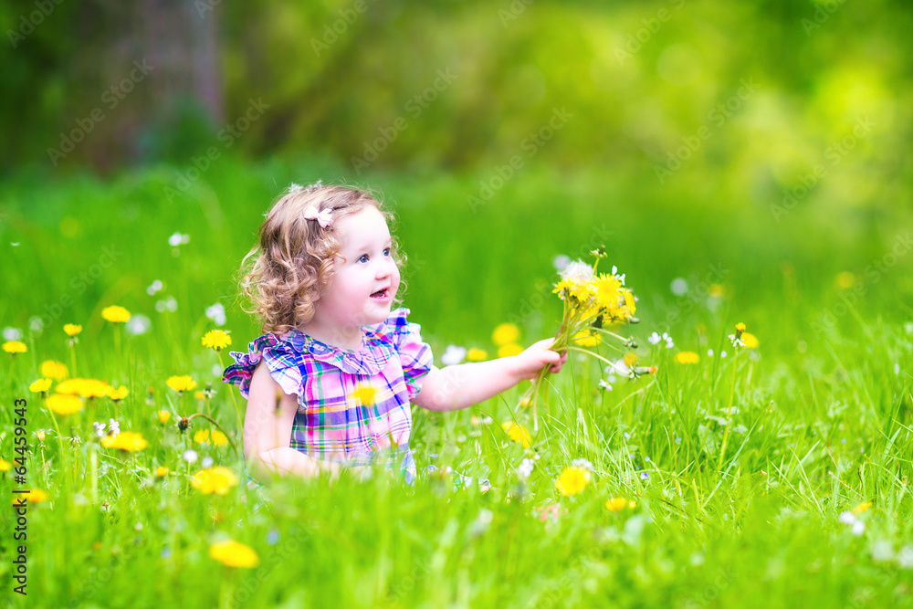 Cute girl playing with dandelions Cute girl playing with dandelions