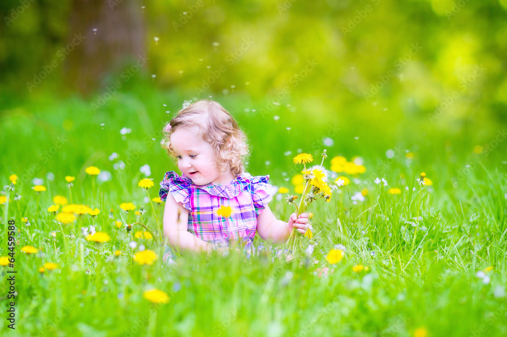 Adorable girl playing with dandelions Adorable girl playing with dandelions
