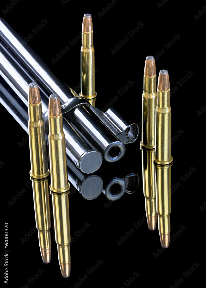 Naklejka premium Brass bullets on the end of a rifle barrel