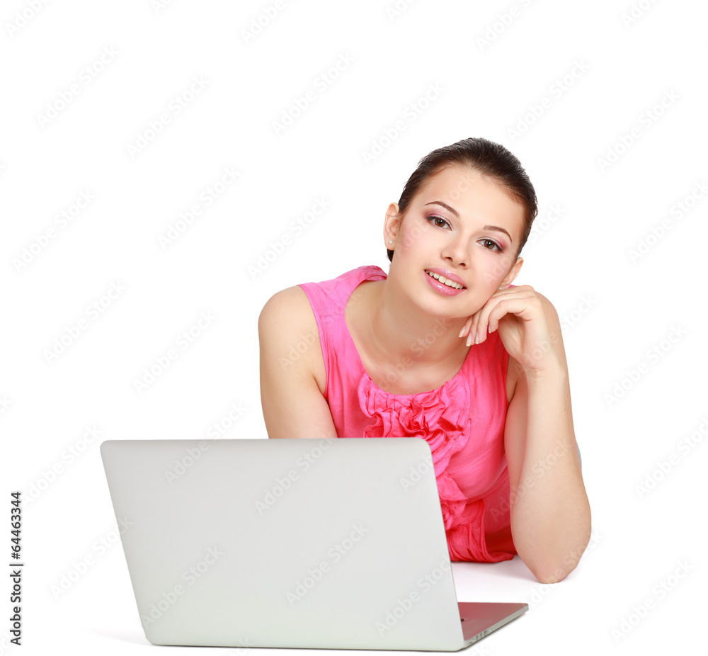 Portrait of beautiful young woman lying on floor with a laptop Portrait of beautiful young woman lying on floor with a laptop