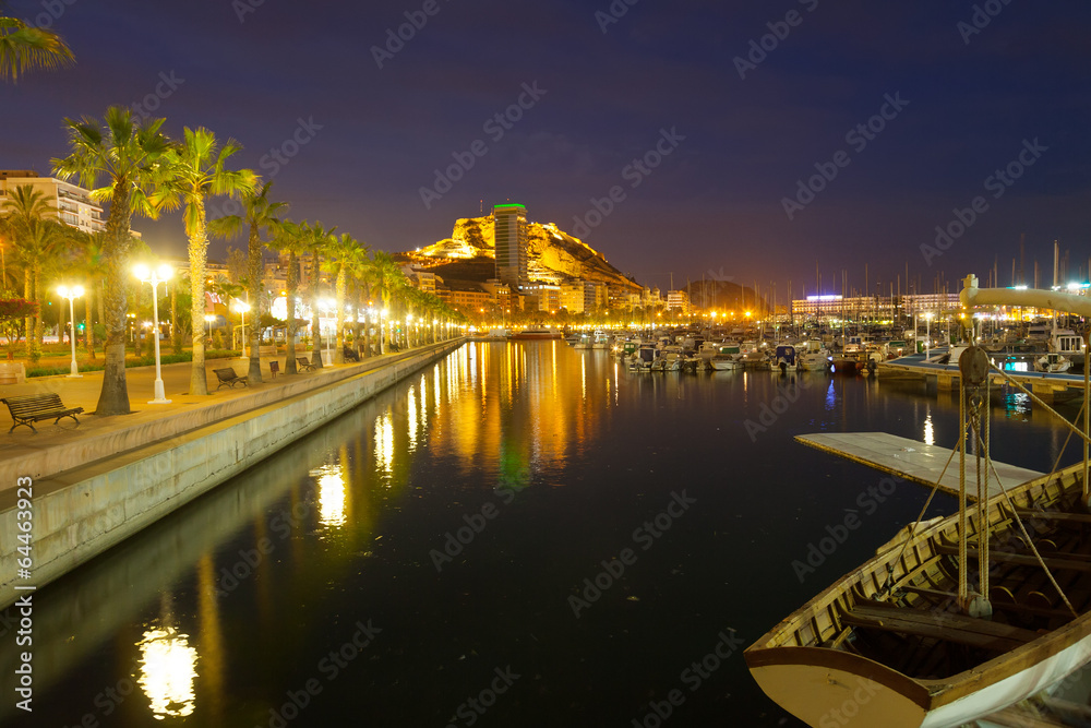Port with yachts and embankment in night. Alicante