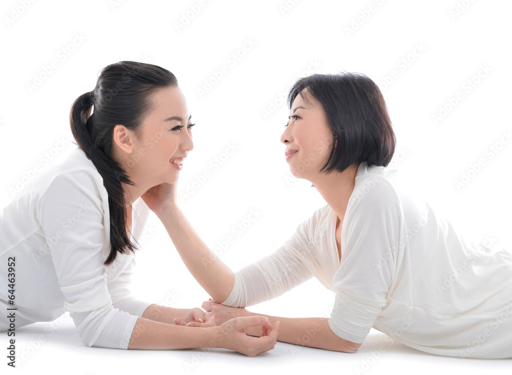 Asian mother and daughter lying down having a fun Asian mother and daughter lying down having a fun