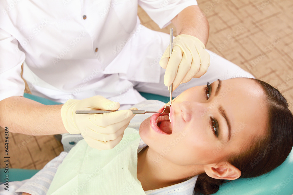 Young woman with dentist in a dental surgery. Young woman with dentist in a dental surgery.