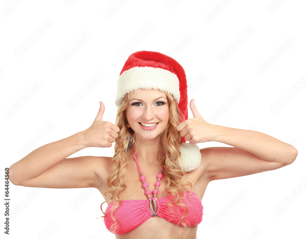 cheerful young woman in santa hat showing ok sign. cheerful young woman in santa hat showing ok sign.