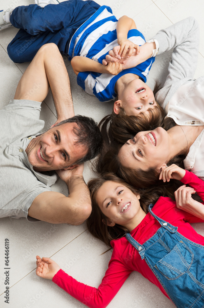 Smiling Family Lying On Floor