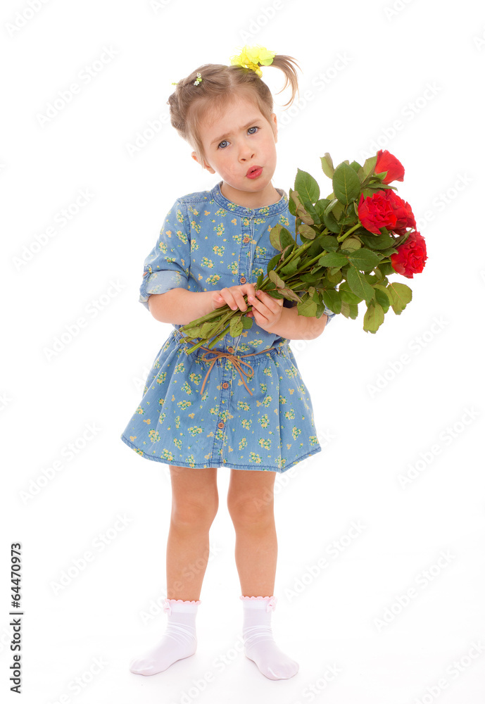 charming little girl holding a bouquet of red roses.
