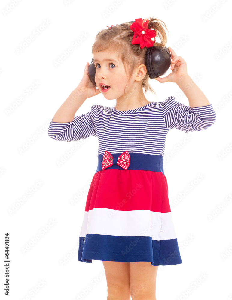 charming little girl in big headphones. charming little girl in big headphones.