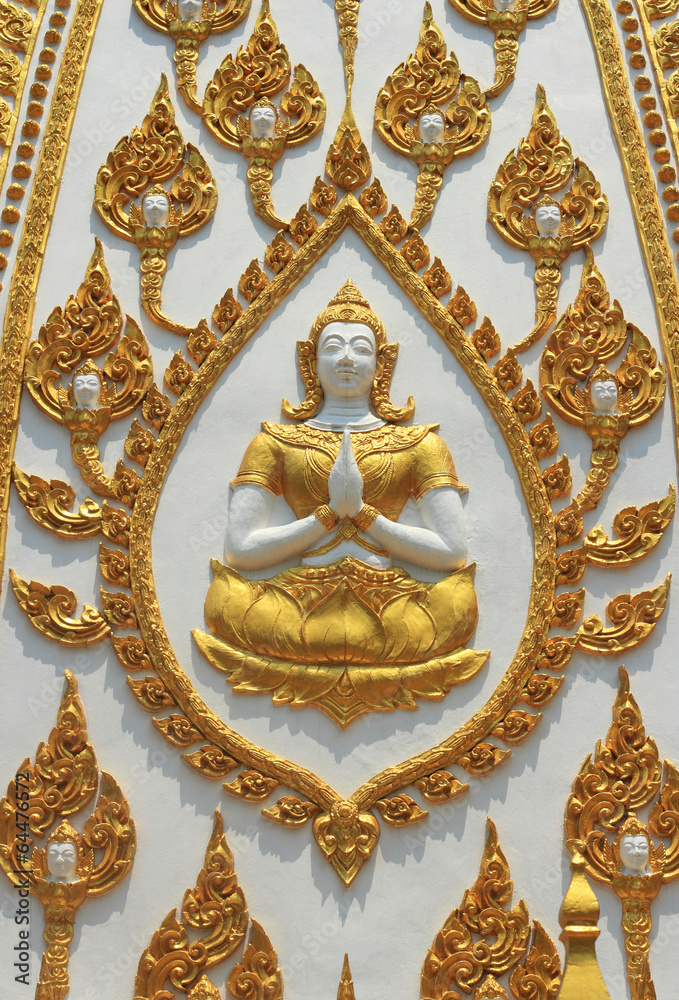 thai style statue and molding art on the wall temple