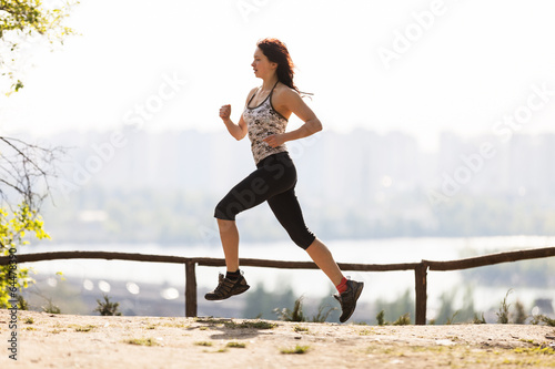 Fototapeta Naklejka Na Ścianę i Meble -  Young woman athlete running in the morning