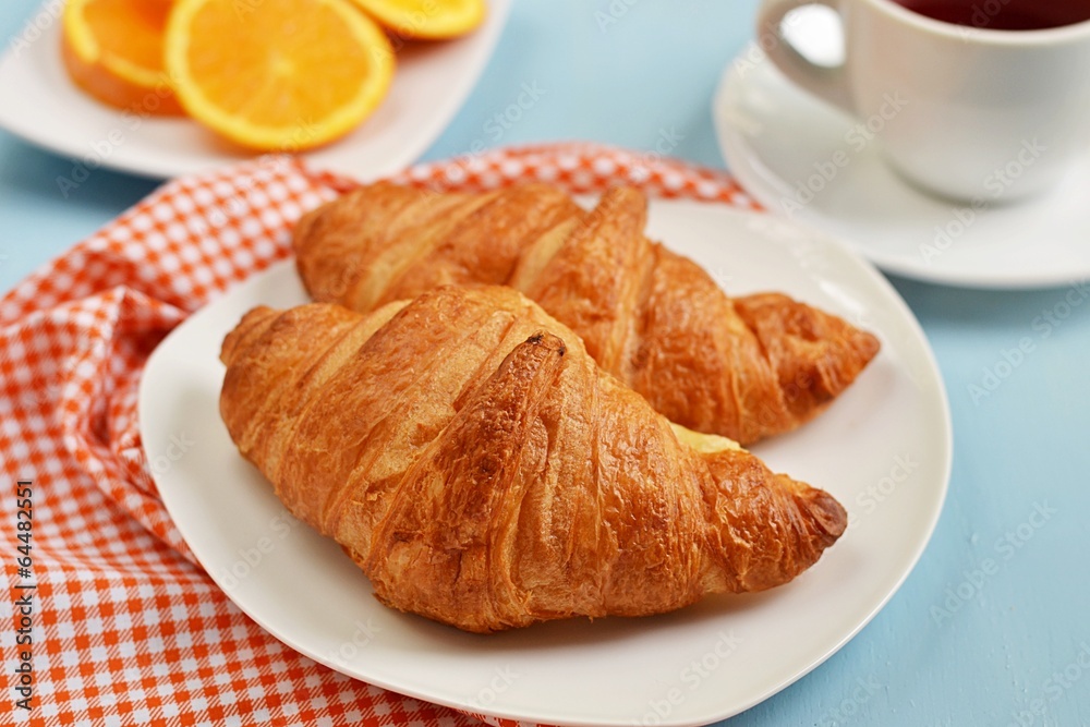 Croissants, tea and orange juice for breakfast Croissants, tea and orange juice for breakfast