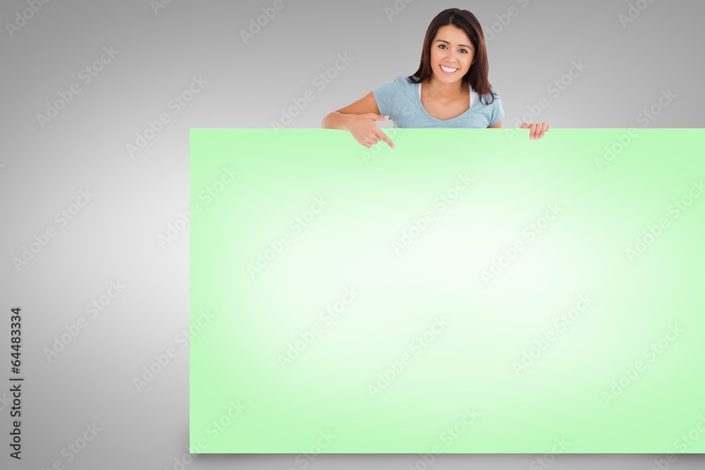 Composite image of pretty brunette showing card Composite image of pretty brunette showing card