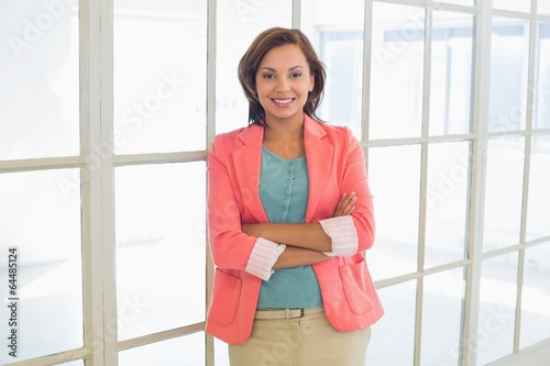 Confident businesswoman with arms crossed at office