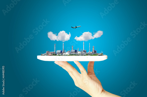 Business woman hold touch pad or tablet with Oil refinery Plant