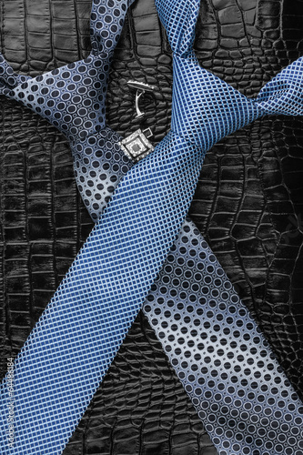 A necktie and cufflinks lying on the skin