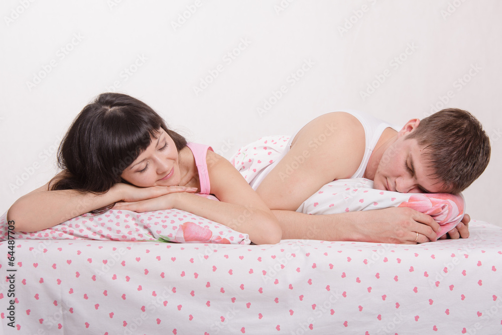 Obraz premium Young couple sleeping in bed