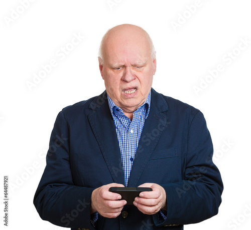 Portrait old man pissed off at a text message, white background  © pathdoc