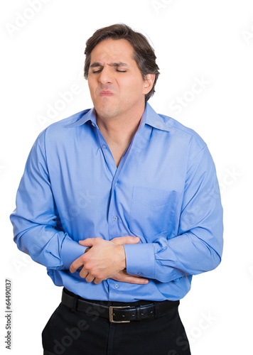 Young man having bad stomach ache, hands on abdomen