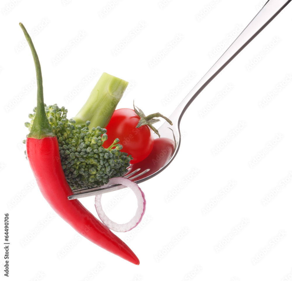 Fresh raw vegetables on fork isolated on white background cutout Fresh raw vegetables on fork isolated on white background cutout