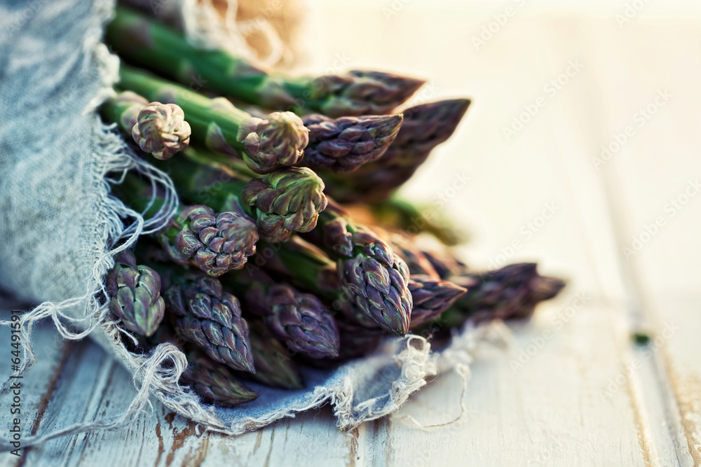 Bunch of fresh asparagus on wooden table Bunch of fresh asparagus on wooden table