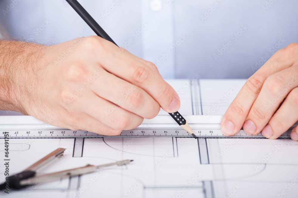 Cropped Image Of Architect Working On Blueprint Cropped Image Of Architect Working On Blueprint