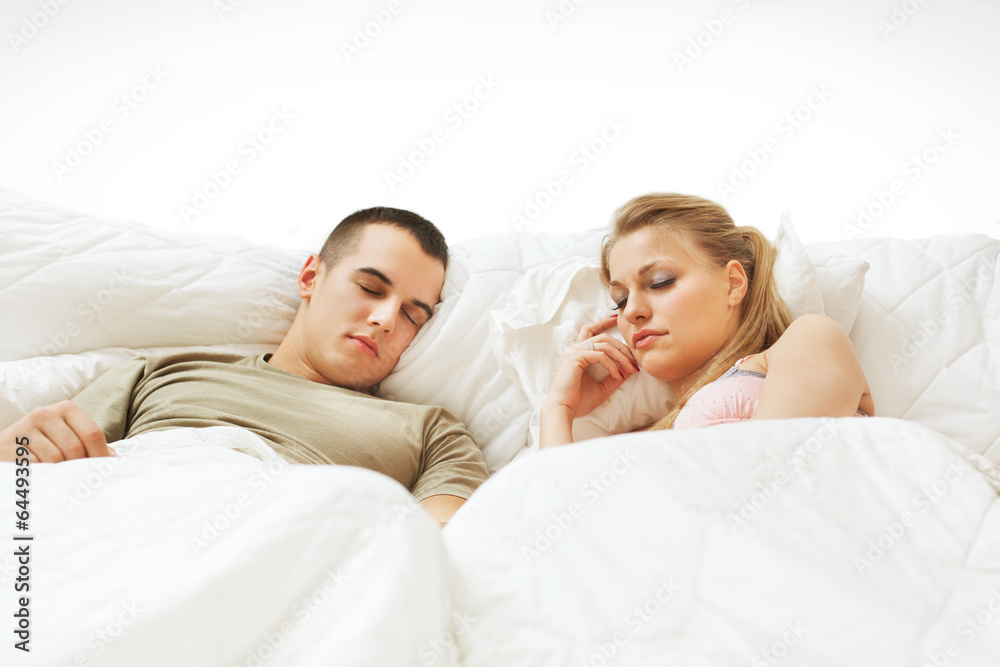 Fototapeta premium Happy young couple sleeping in the bed .