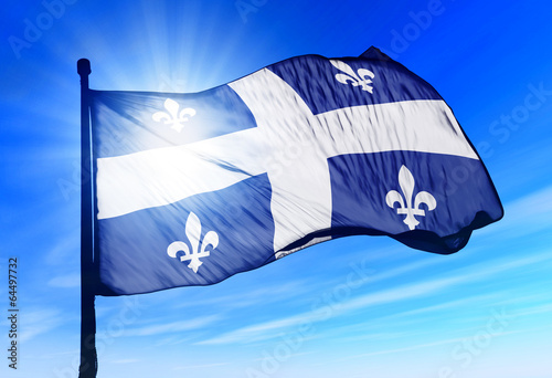 Quebec (Canada) flag waving on the wind photo