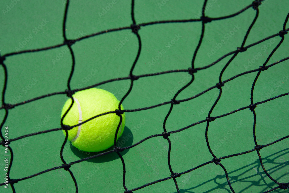 tennis ball on green court