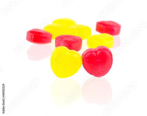 Red and yellow candy hearts isolated on white background