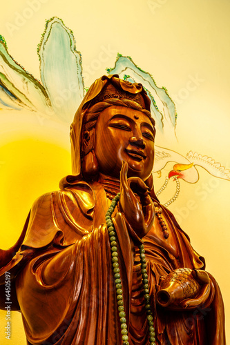 Wood carving of Guan yin photo