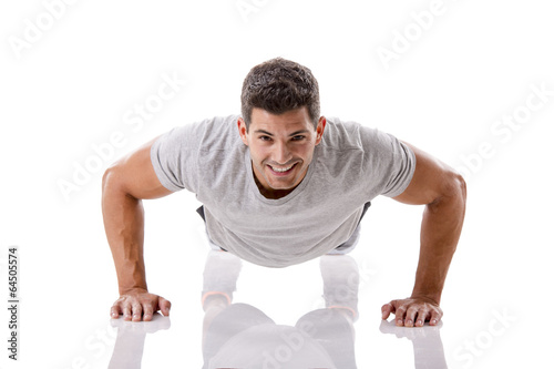 Handsome young man making pushups photo