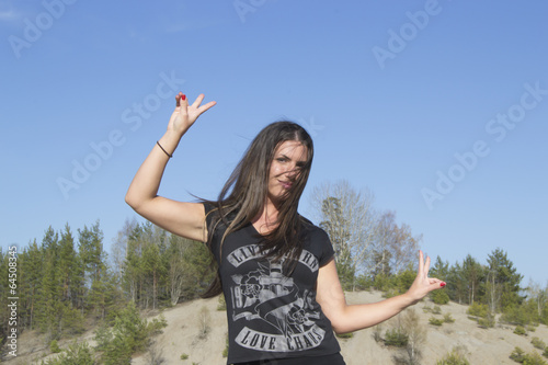 Happy woman showing peace sign with her hands