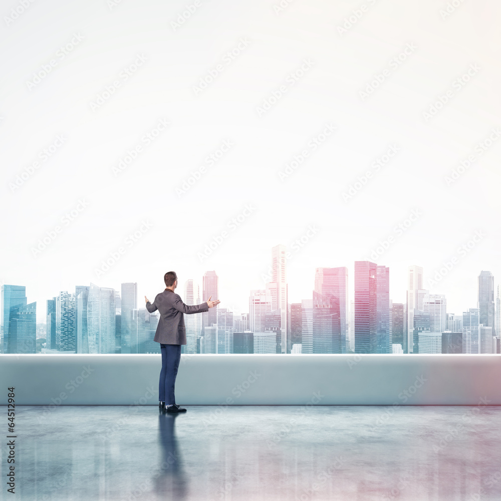 business man standing on a roof and looking at city business man standing on a roof and looking at city